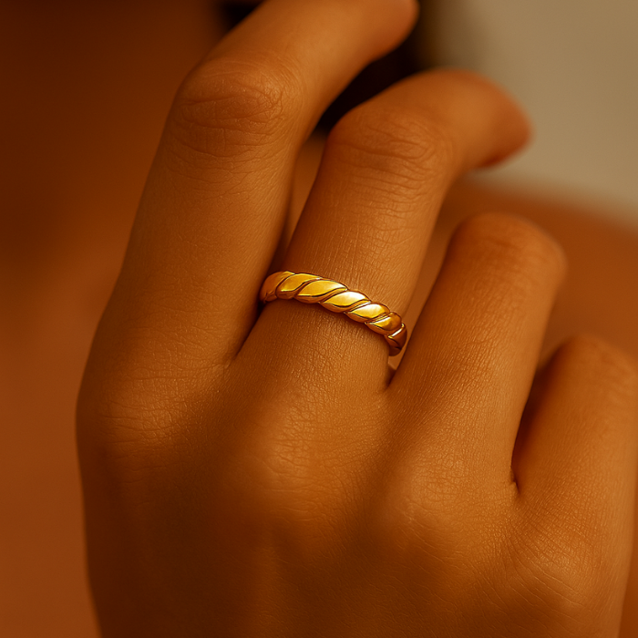 Twisted gold titanium ring on hand