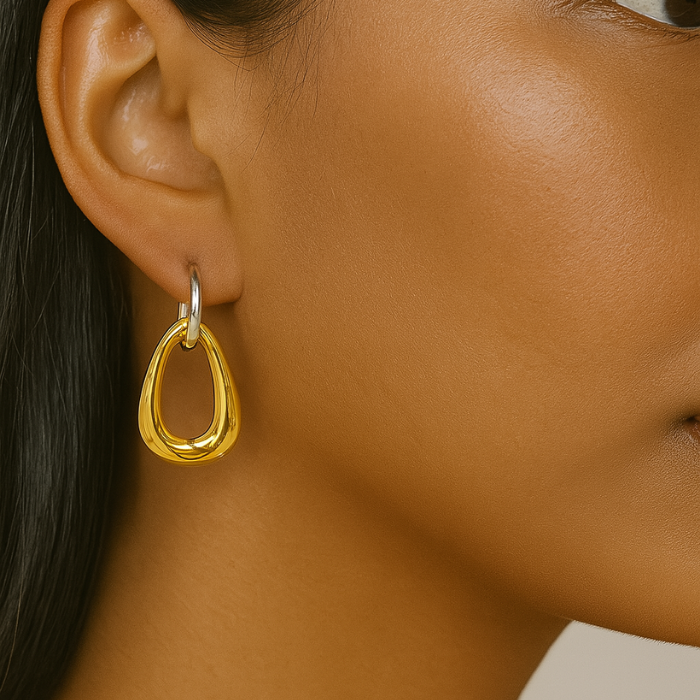 asymmetrical gold earrings on model