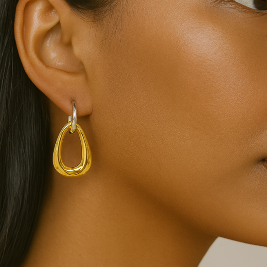 asymmetrical gold earrings on model