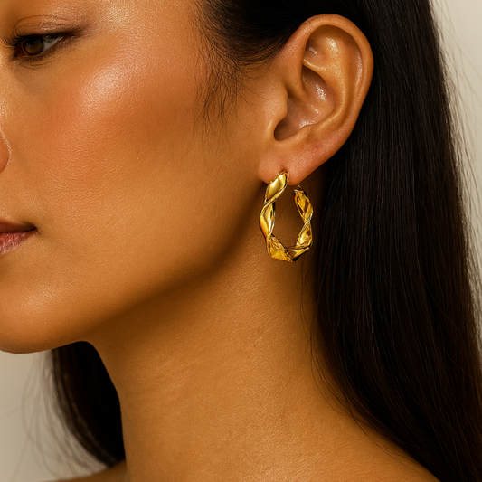 gold wavy twist hoop earrings on model